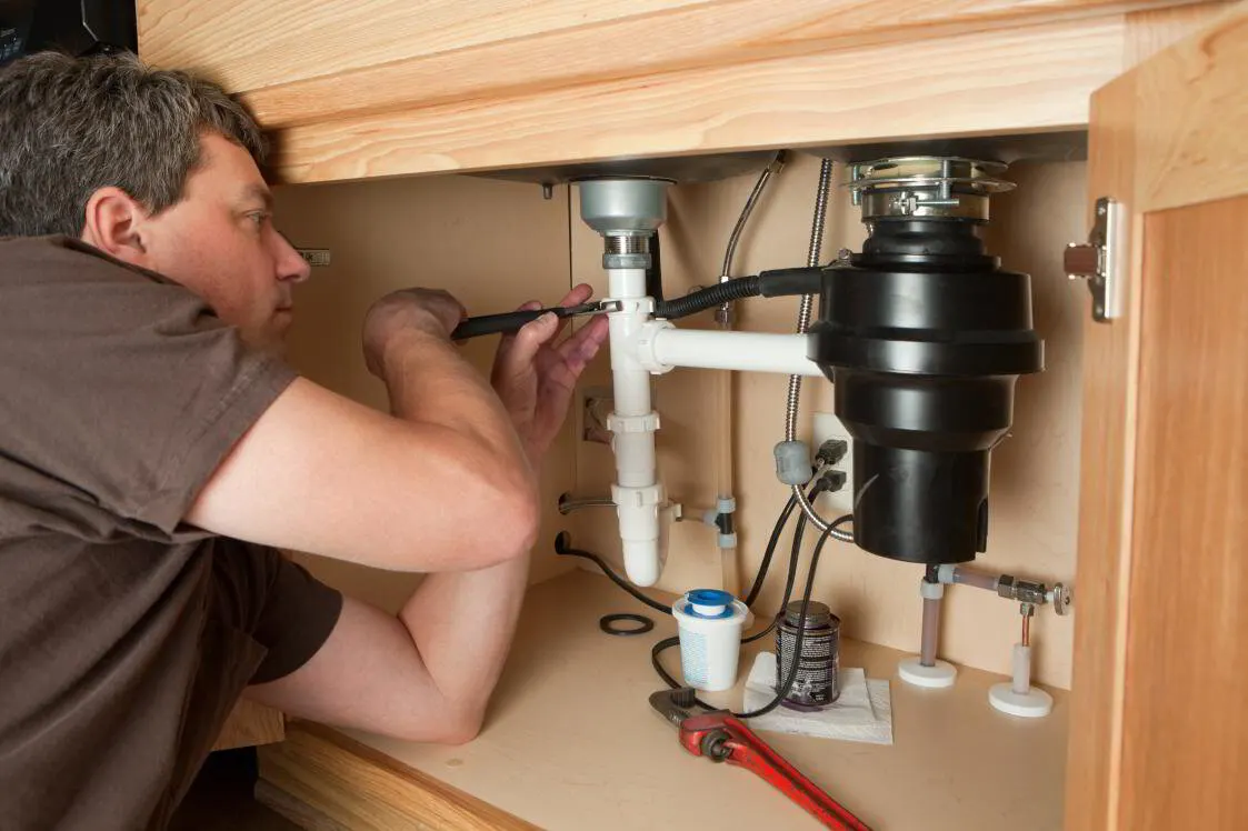 Garbage disposal installed beneath a sink in an older Akron, Ohio kitchen