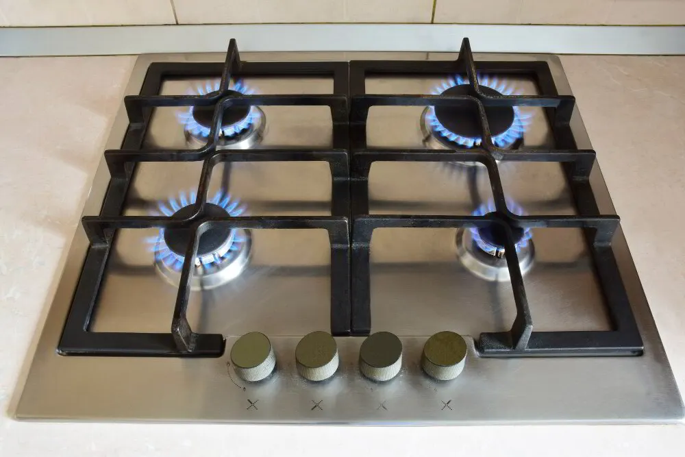 Anti-tip bracket being installed behind a gas stove in Tallmadge, Ohio
